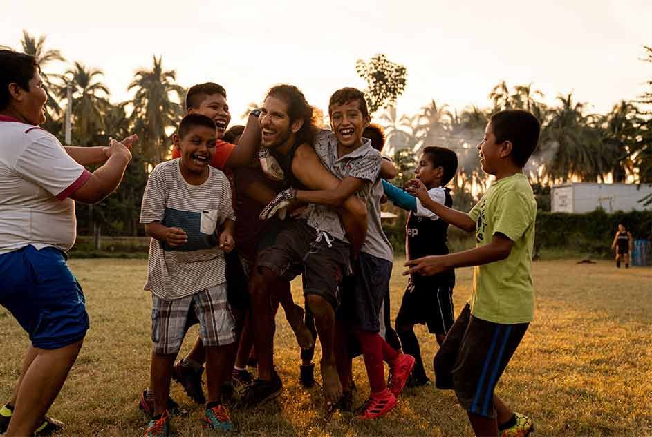 A group of children are playing a game in a field.