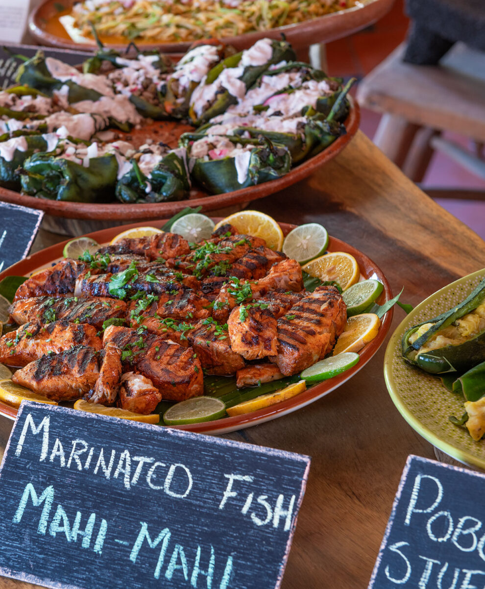 Two vegetable rolls with sesame seeds on a plate on a table.