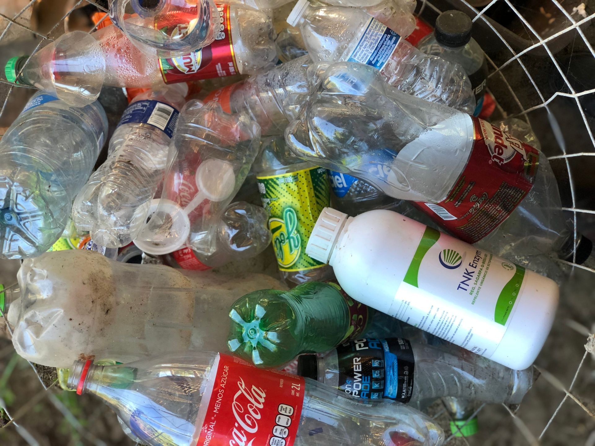 A pile of plastic bottles including a coca cola bottle