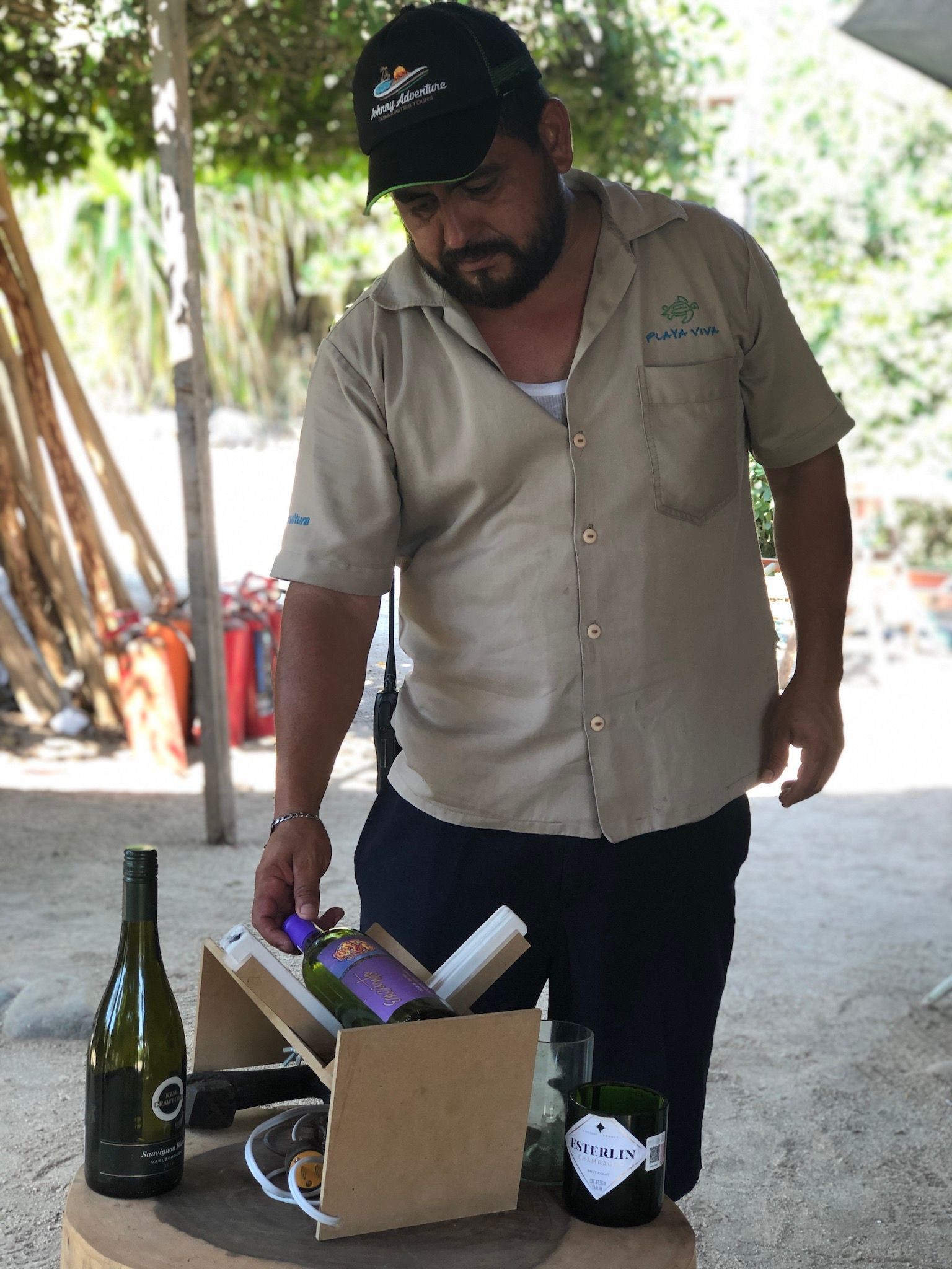 A man is pouring a bottle of wine into a glass