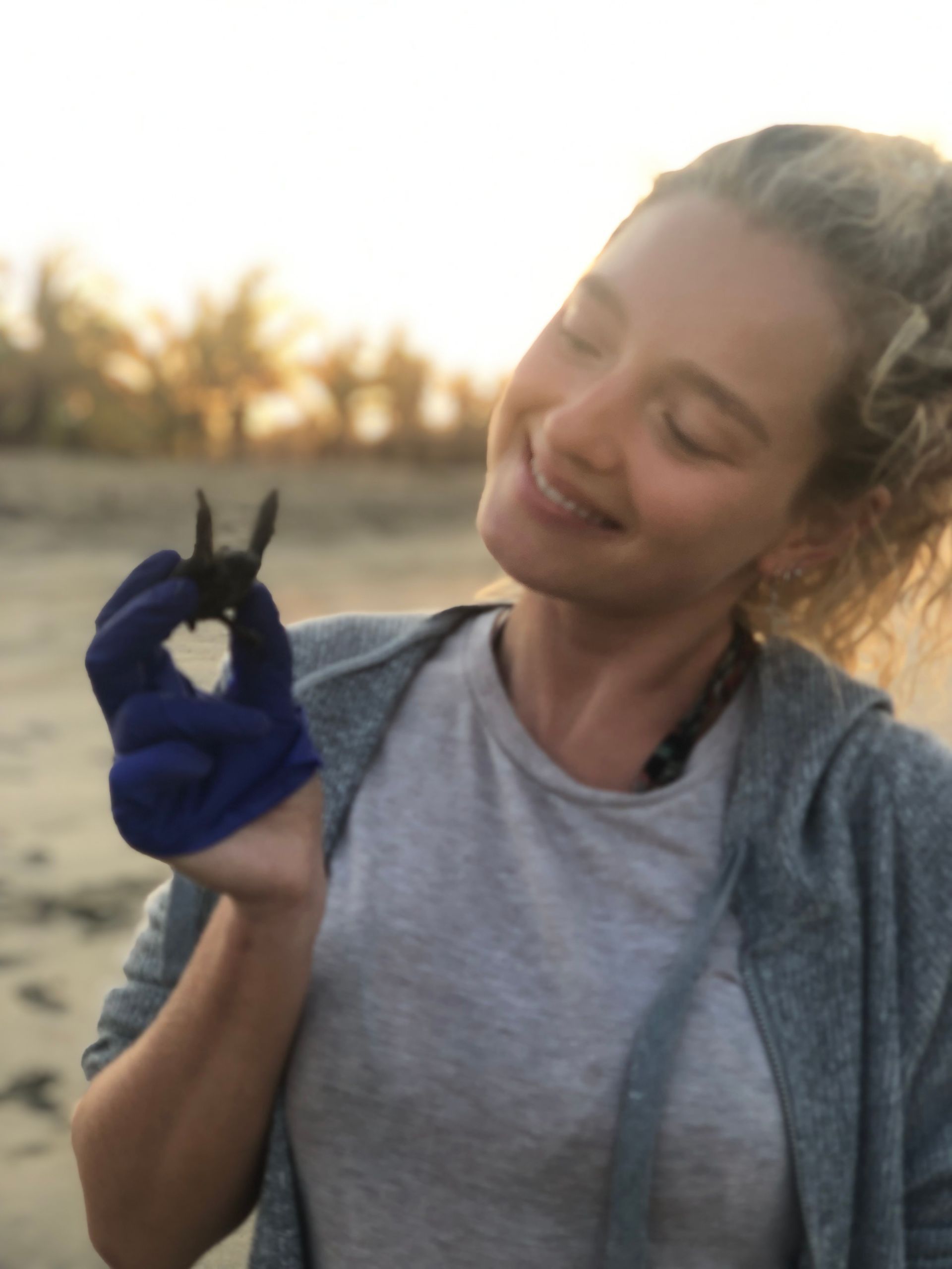 A woman is holding a heart shaped object in her hand