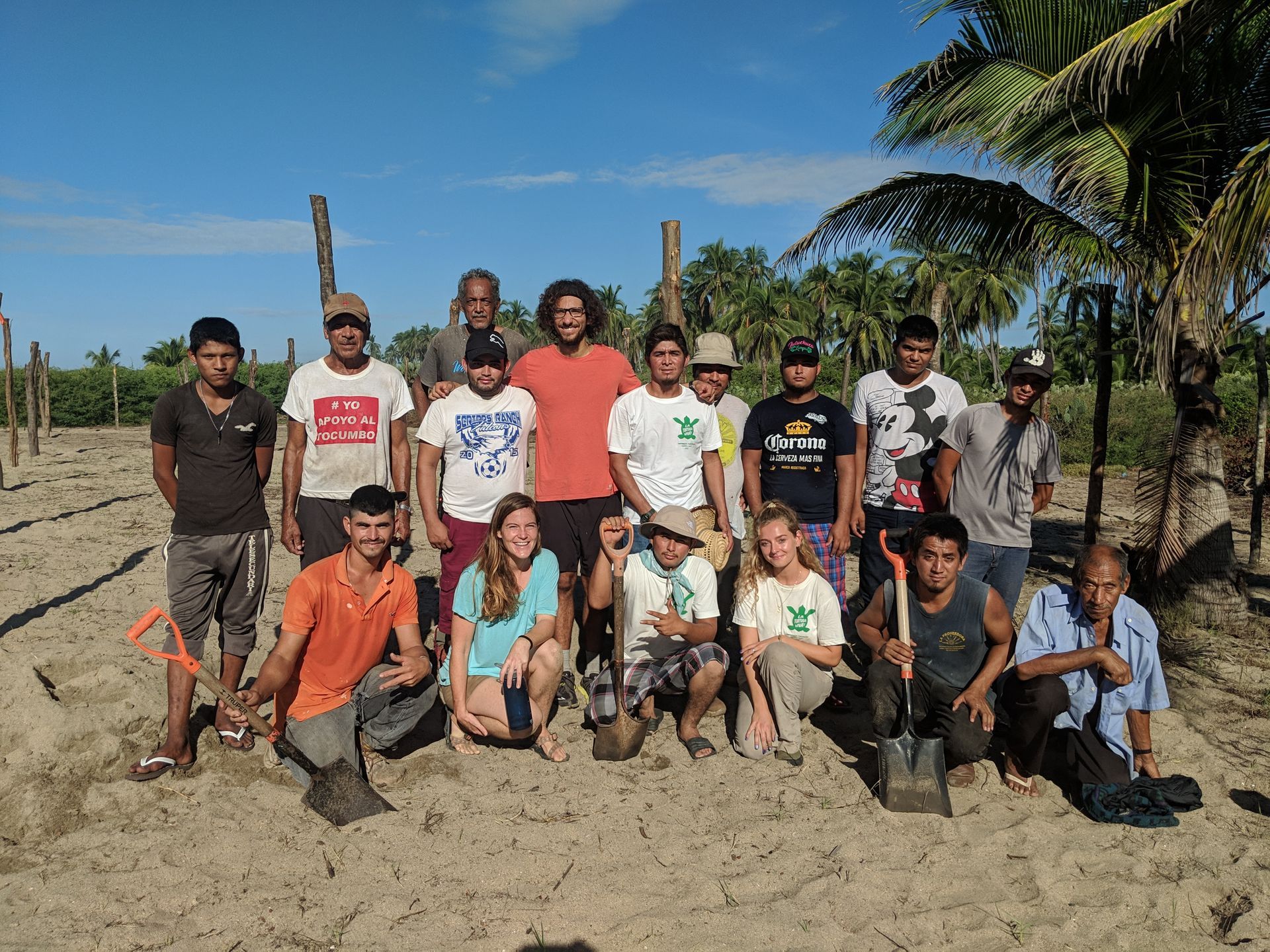 A group of people posing for a picture on the beach