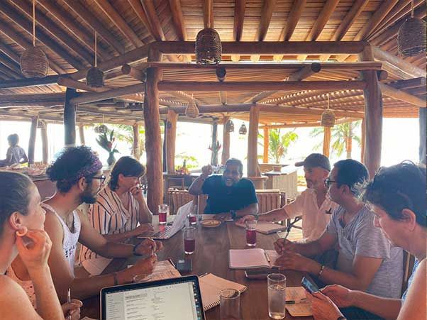 A group of people are sitting around a table in a restaurant.