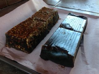 Two brownies are sitting on a piece of wax paper