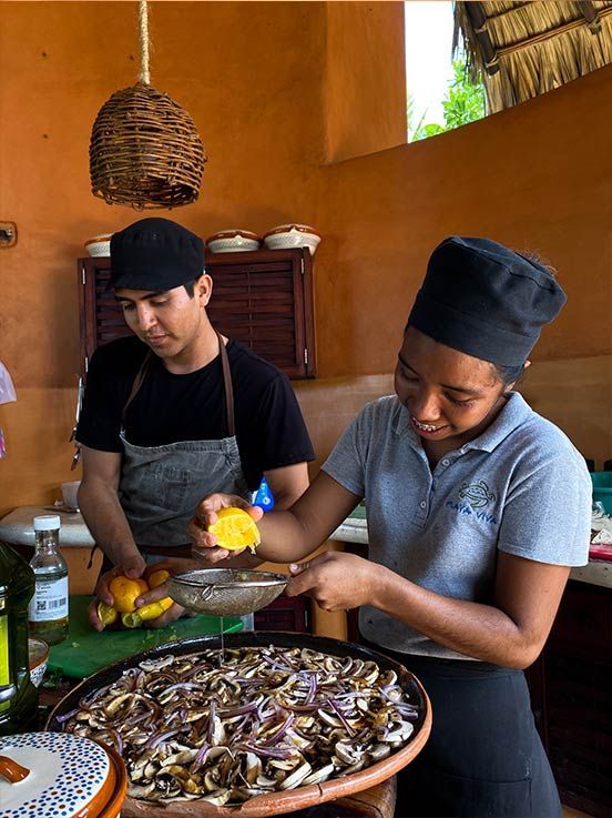 A man and a woman are preparing food in a kitchen.
