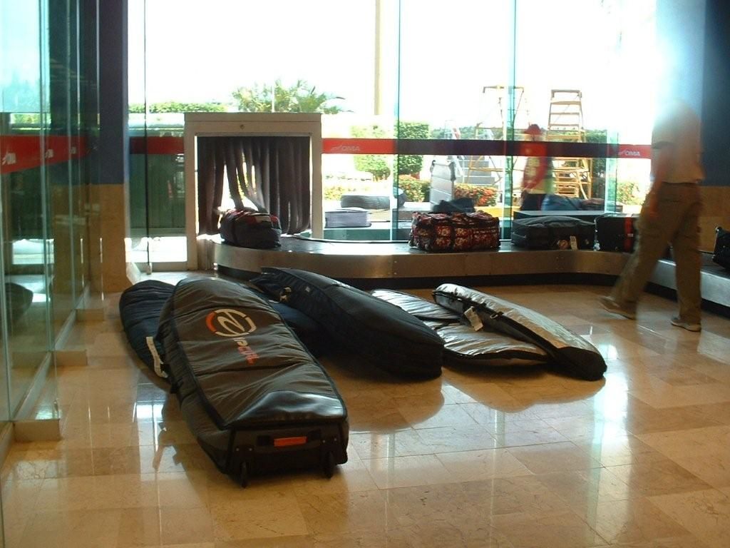 A bunch of surfboards are laying on the floor