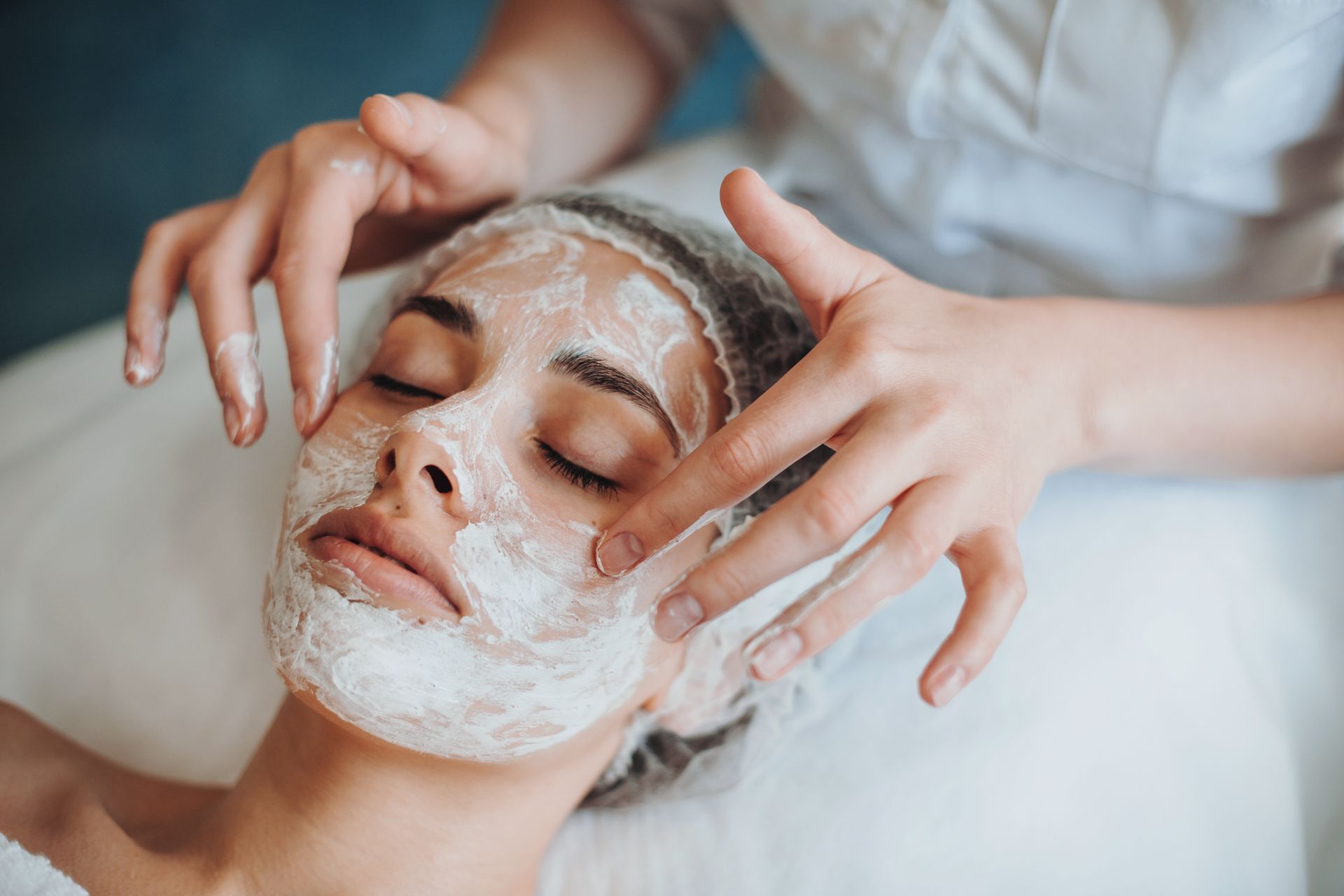 A woman is getting a facial treatment at a spa.
