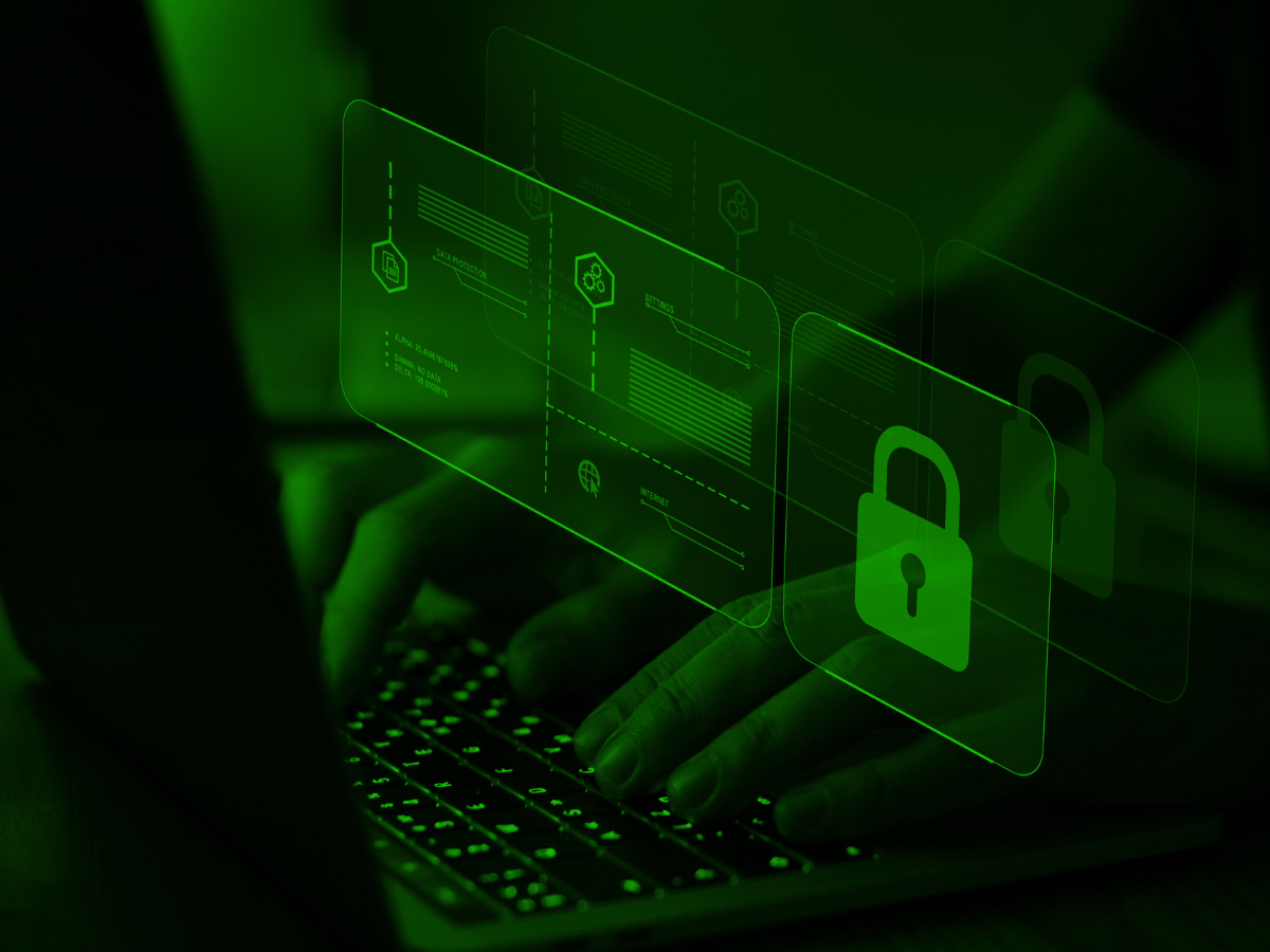 Hands typing on a laptop, overlaid with a green padlock and login interface, suggesting cybersecurity.
