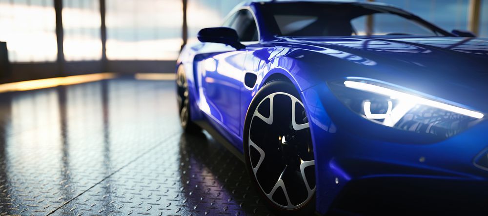 A blue sports car is parked in a garage.