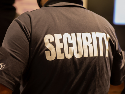 A security guard in a dark shirt with 