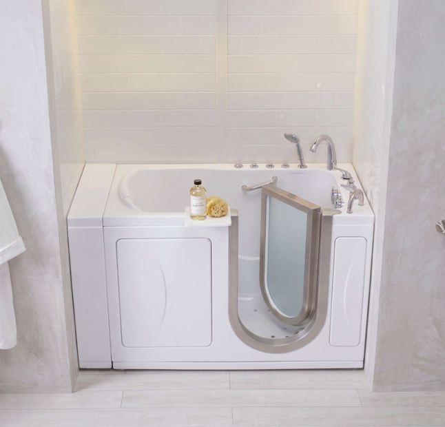 Walk-in bathtub with open safety door, filled with water, in a tiled bathroom