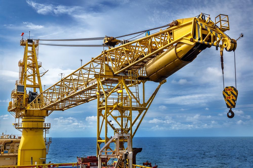 A Large Yellow Crane is Sitting in the Middle of the Ocean — Linmar Cranes & Haulage in Birdsville, QLD