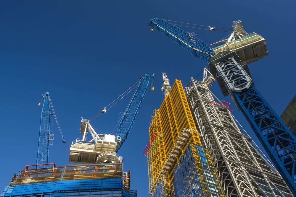 A Building is Being Built With Cranes and a Blue Sky in the Background — Linmar Cranes & Haulage in Cloncurry, QLD