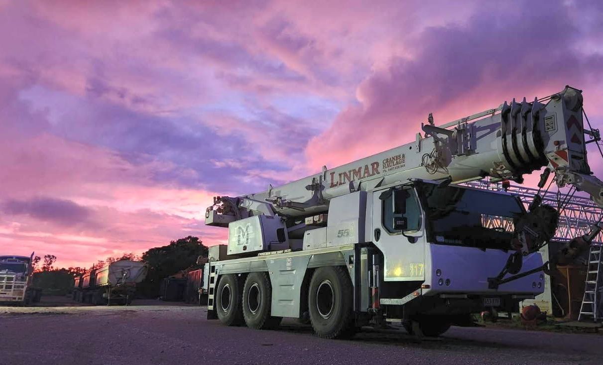White Linmar Crane with pink skies — Linmar Cranes & Haulage in Kalkadoon, QLD
