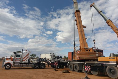 A Truck is Being Towed by a Large Crane — Linmar Cranes & Haulage in Kalkadoon, QLD