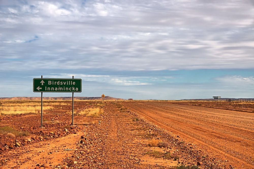 A Sign on The Side of A Dirt Road Shows the Way to Birdsville — Linmar Cranes & Haulage in Birdsville, QLD