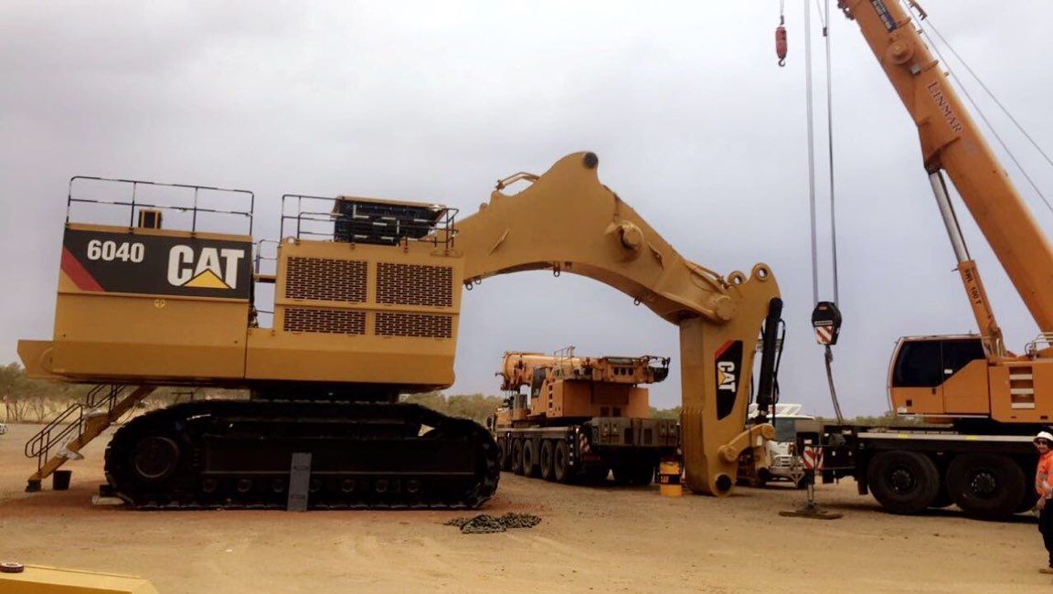 A CAT Excavator is Being Lifted by a Crane — Linmar Cranes & Haulage in Kalkadoon, QLD