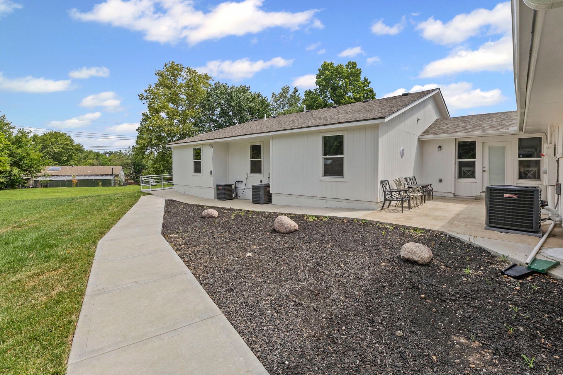 A white house with a walkway leading to it
