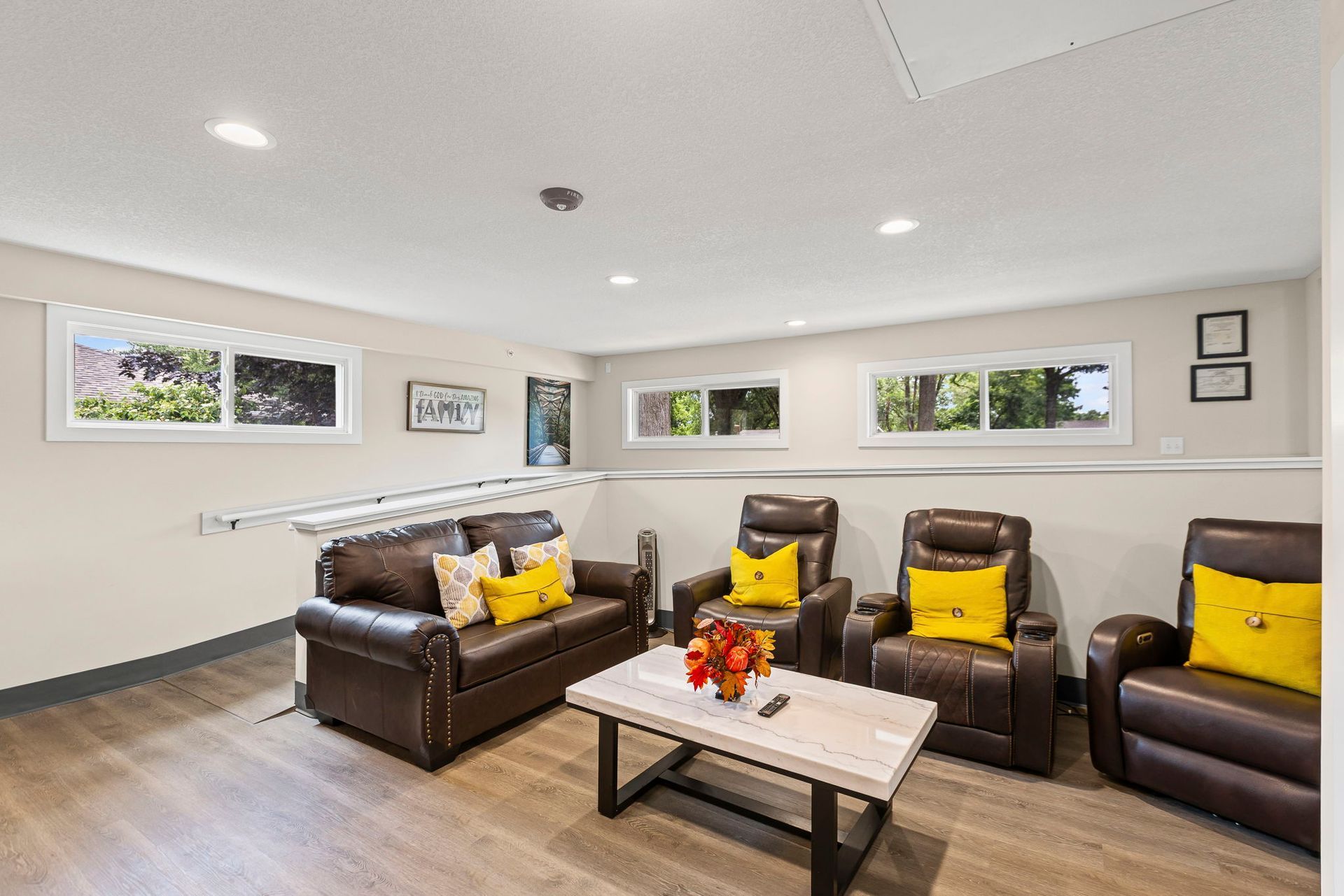A living room with a couch , chairs , and a coffee table.