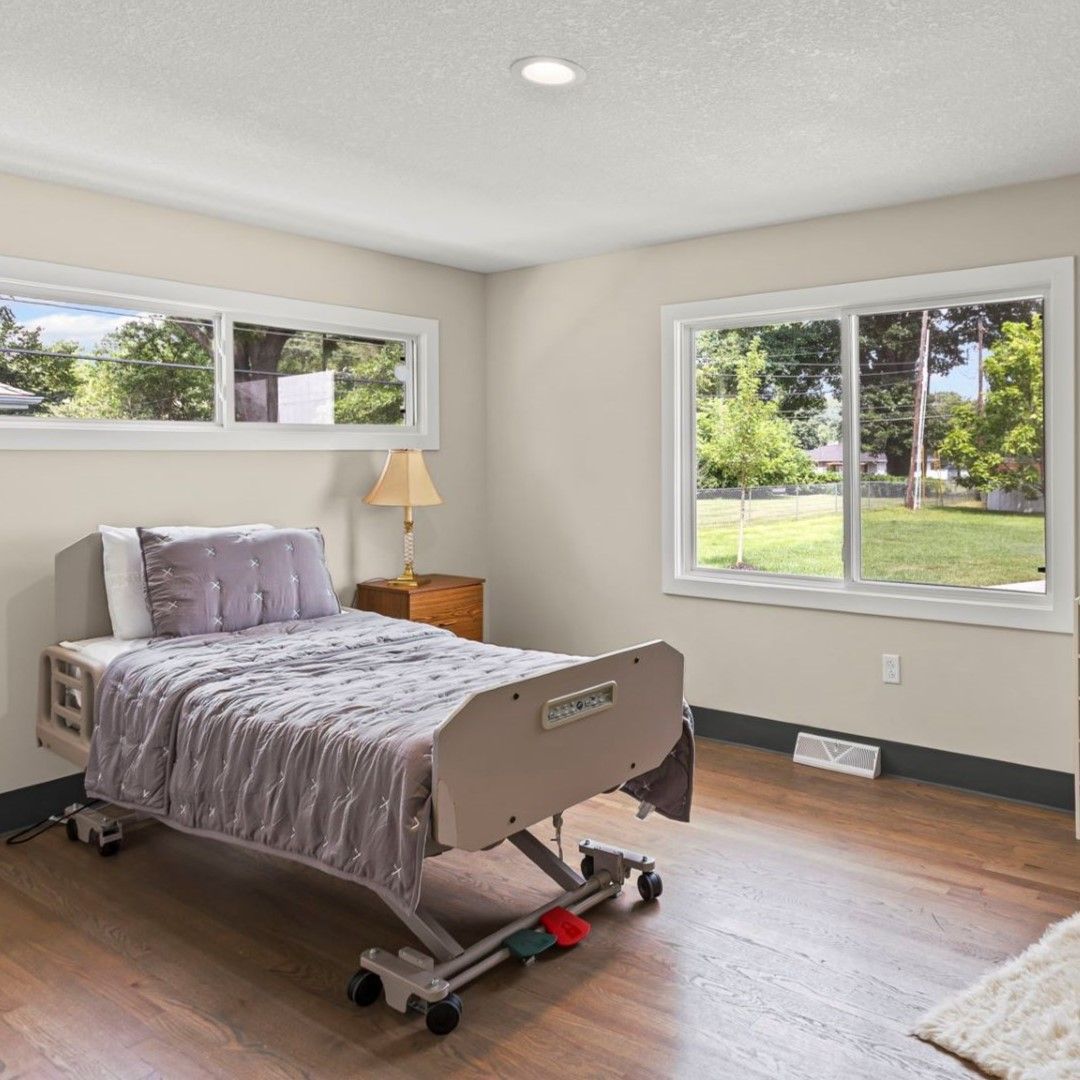 There is a hospital bed in the middle of the room.