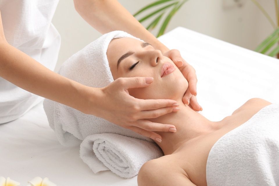 A young woman with a facial massage