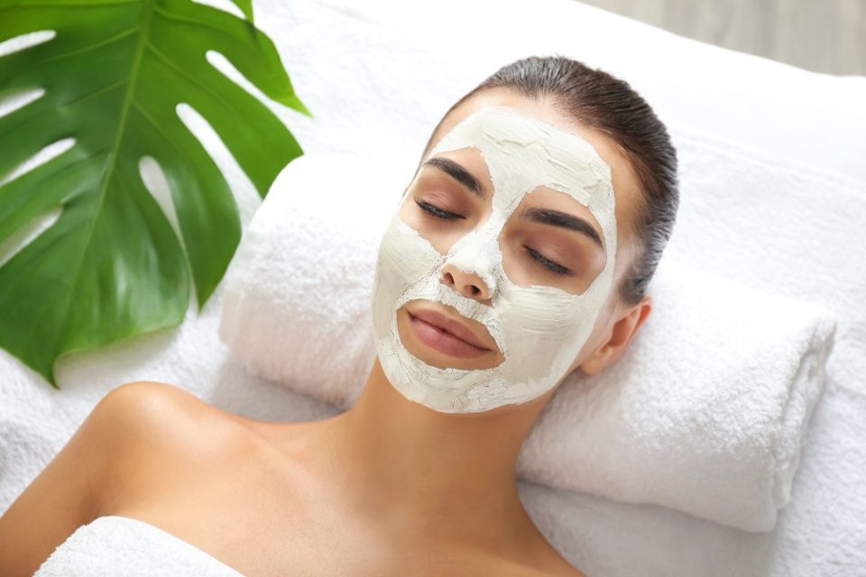 Beautiful young woman with facial mask