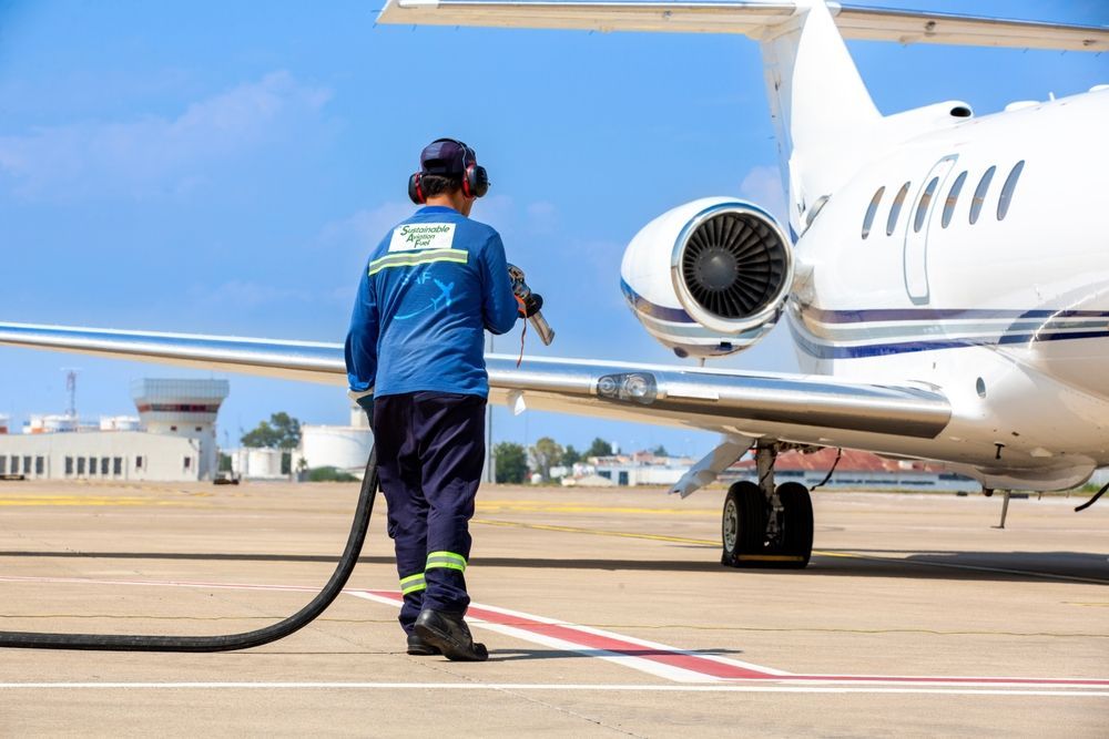 A man is walking towards an airplane on the runway.