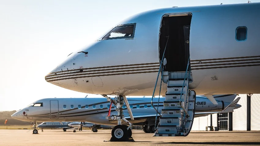 Business traveller reviewing insurance documents next to a charter jet before a flight