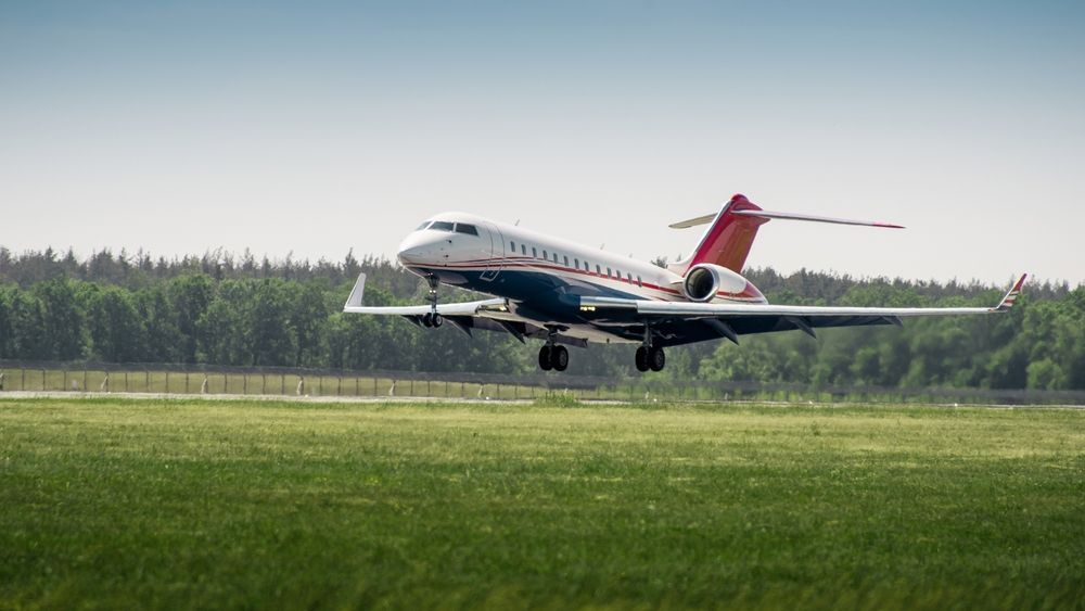 A small airplane is taking off from an airport runway.