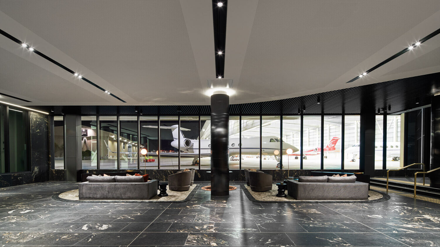 Modern interior of a Melbourne private jet terminal with concierge and seating areas

