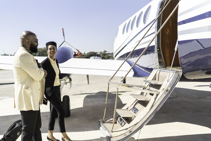 Passenger booking a flight through private jet membership program with a streamlined app for easy booking and travel
