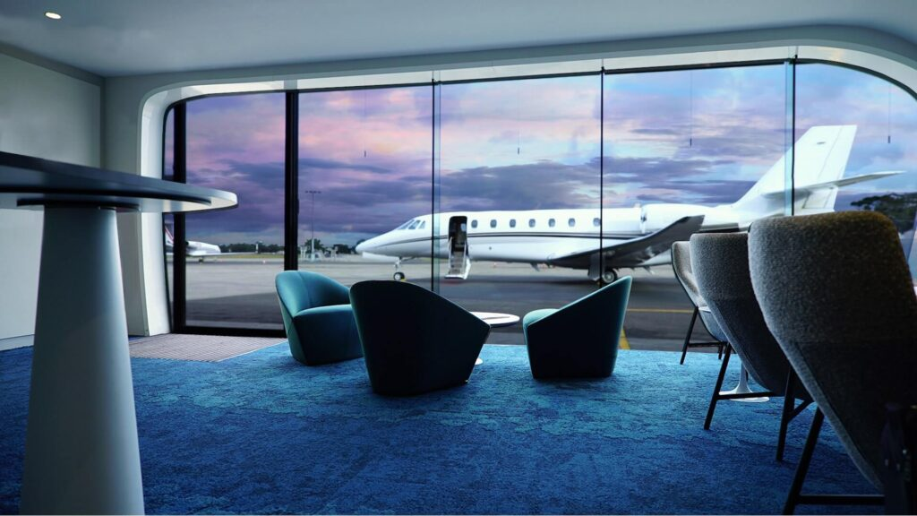 Modern private jet terminal (FBO) in Australia with travellers and staff in a luxury lounge