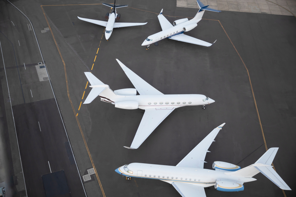 A group of planes are parked on a runway