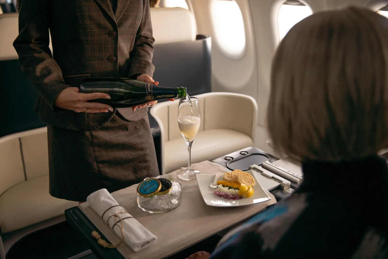 Elegant gourmet meals being served on a private jet cabin, highlighting the latest winter trends