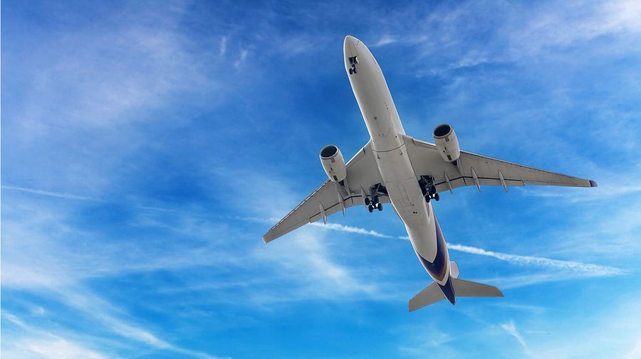 an airplane is flying through the blue sky