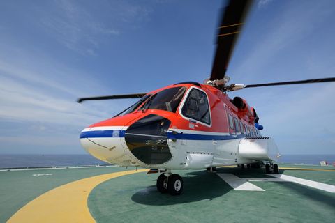 a helicopter sitting on top of an airport tarmac