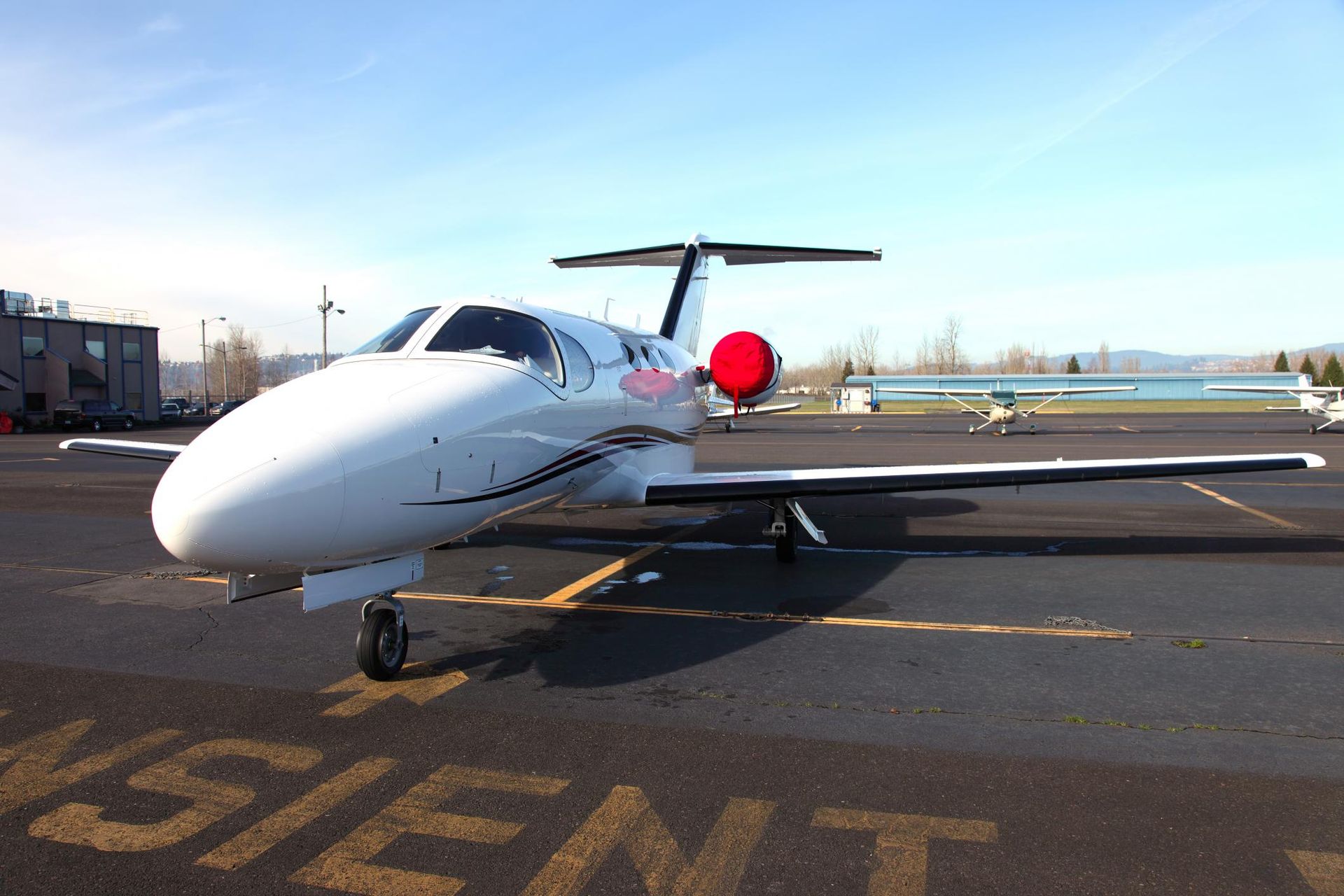 a small white airplane parked on a runway