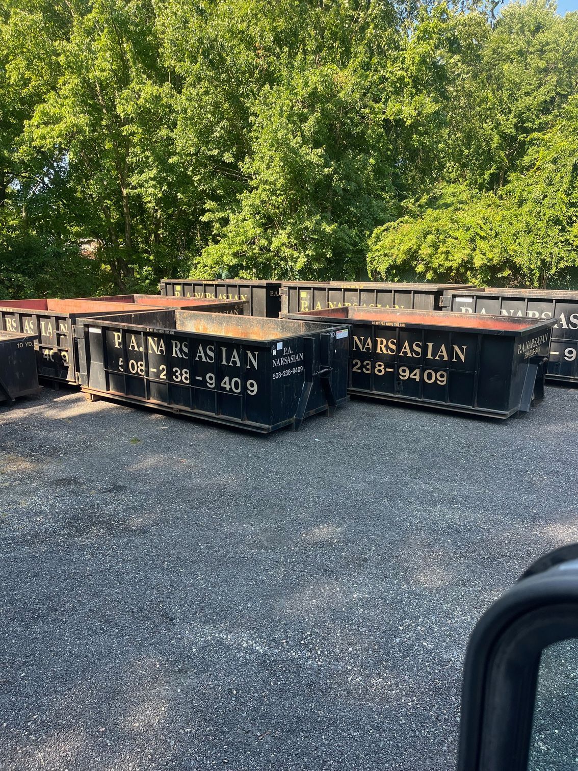Several black dumpsters marked 
