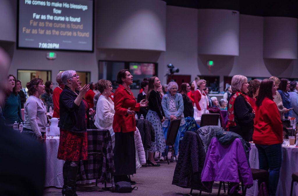 A large group of people are standing in a room.