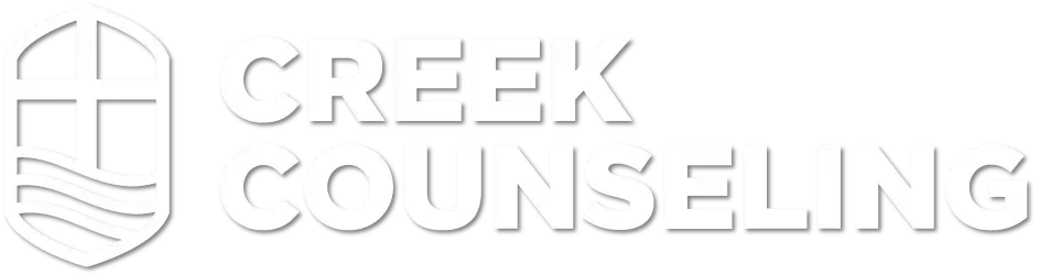 A white logo for creek counseling with a cross and shield.