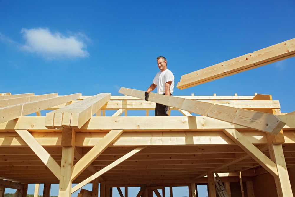 Carpenter Working On The Rafters For A Timber Roof Truss — Trussted Frames & Trusses in Central Coast, NSW