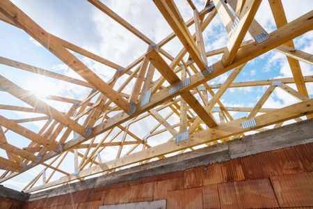 The Roof of A House Is Being Built with Wooden Beams  — Trussted Frames & Trusses in Bennetts Green, NSW