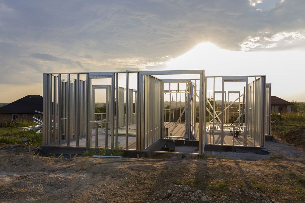 A Wooden House Is Being Built In The Middle Of A Field — Trussted Frames & Trusses in Armidale, NSW