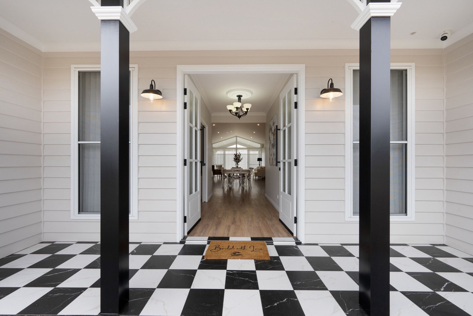 Entrance With Black and White Checkered Floor, Black Columns, and Double Doors Leading Into a Bright Hallway — Trussted Frames & Trusses in Bennetts Green, NSW