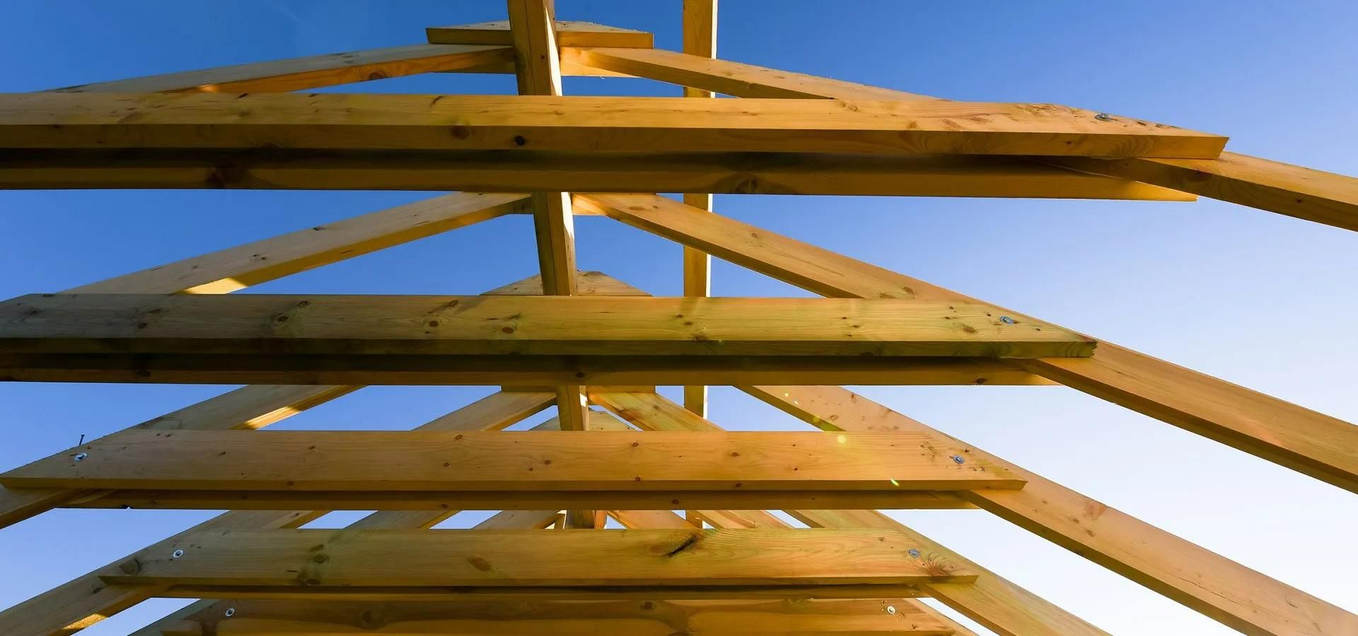 Looking up At a Wooden Structure with A Blue Sky in The Background — Trussted Frames & Trusses in Bennetts Green, NSW