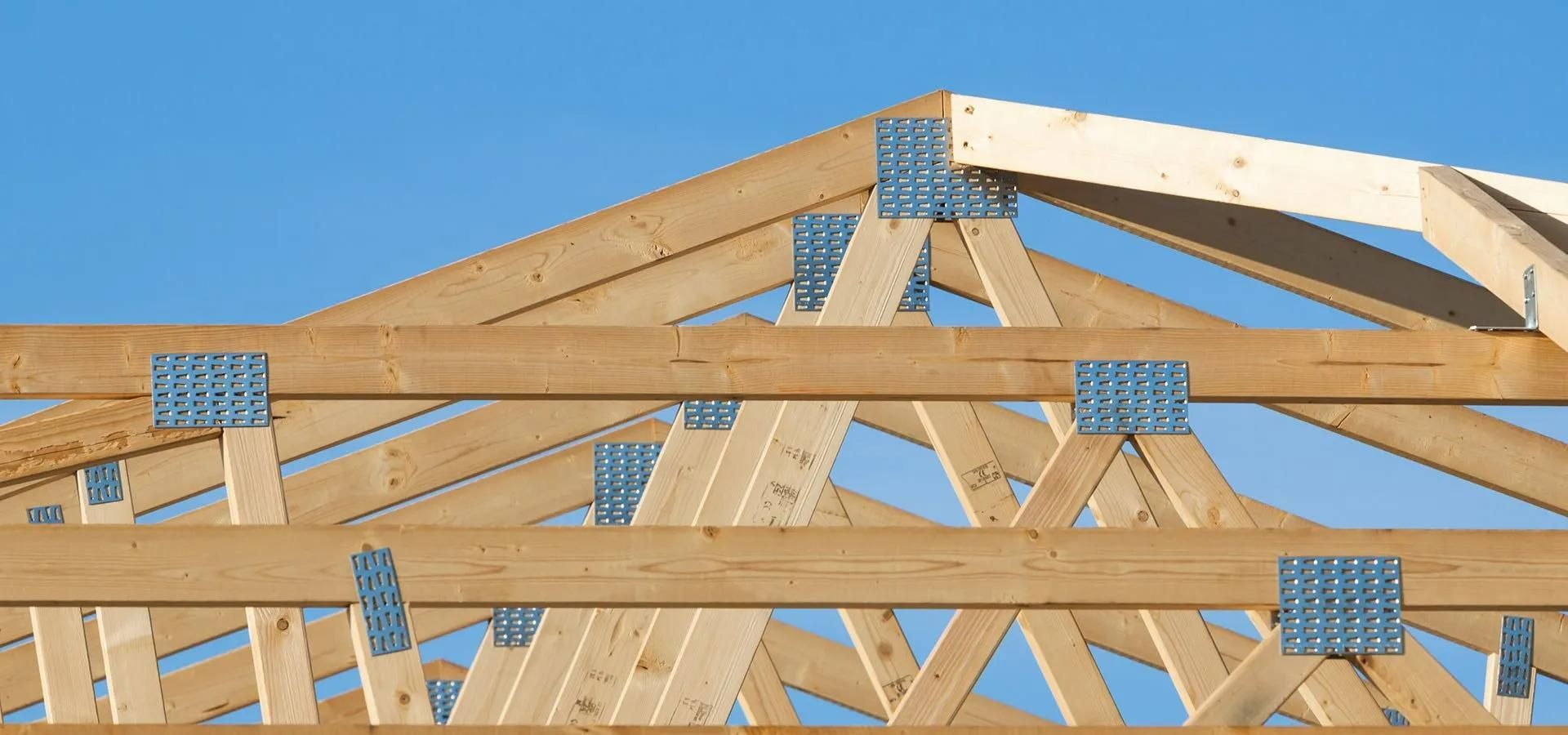 A Close up Of a Wooden Structure with A Blue Sky in The Background — Trussted Frames & Trusses in Bennetts Green, NSW