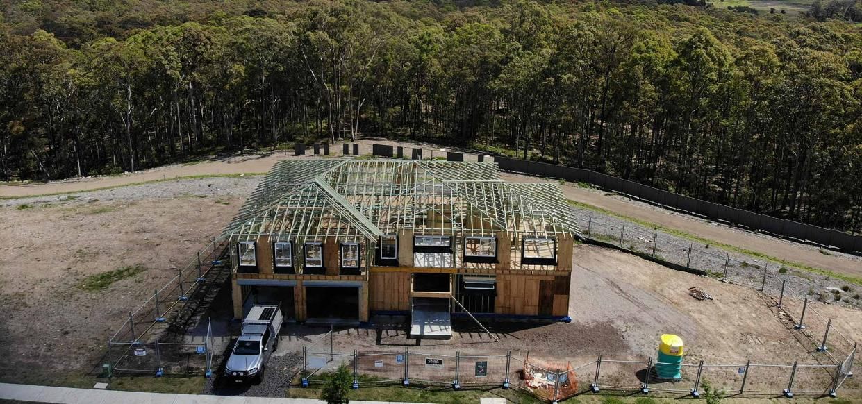 An Aerial View of A House Under Construction in The Middle of A Forest — Trussted Frames Trusses in Bennetts Green, NSW