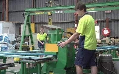 A Man Is Working on A Machine in A Factory — Trussted Frames Trusses in Bennetts Green, NSW