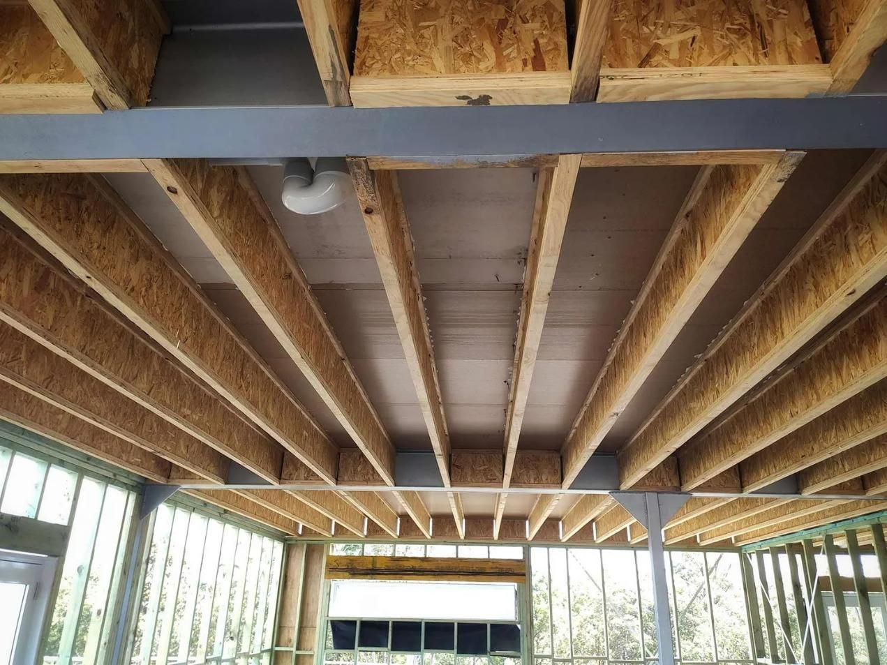The Ceiling of A Building Under Construction with Wooden Beams — Trussted Frames Trusses in Bennetts Green, NSW