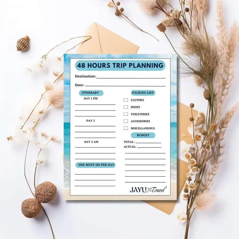 A 48 hours trip planning sheet is sitting on top of a table next to flowers.